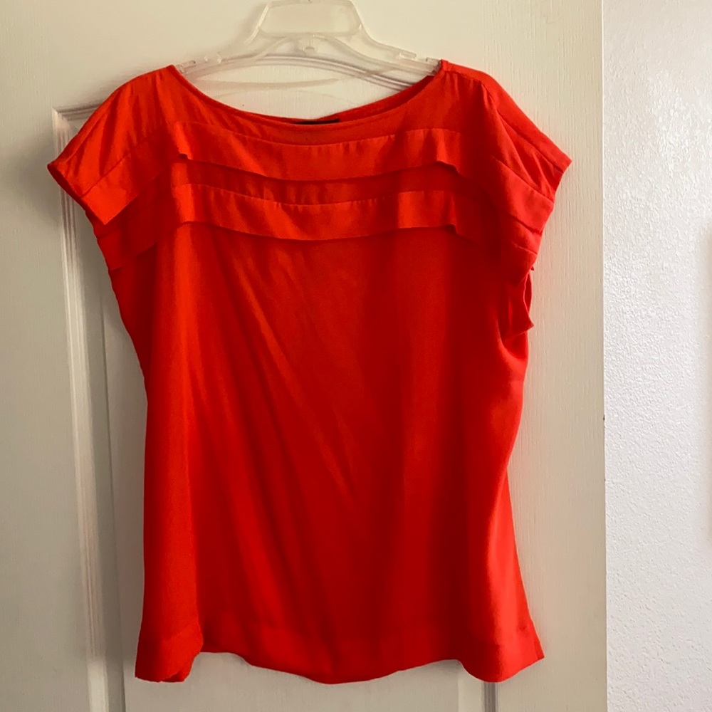 Bright orange size L short sleeve. Great for layering with blazer or cardigan